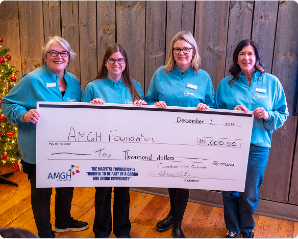 AMGH Foundation team holding a donation cheque